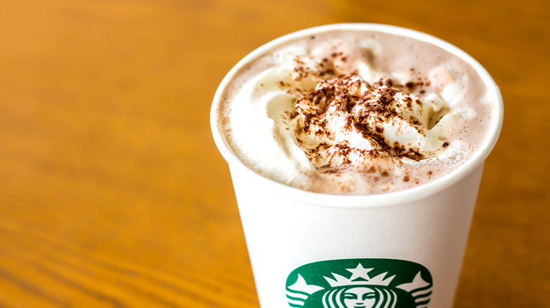 A Starbucks latte sprinkled with pumpkin spice topping
