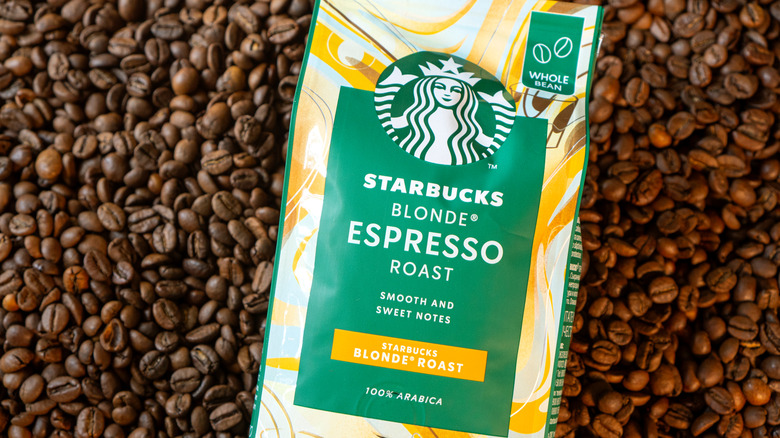 A bag of Starbucks Blonde Espresso Roast on a pile of coffee beans