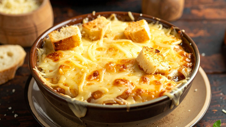 Bowl of French onion soup topped with melted cheese and croutons