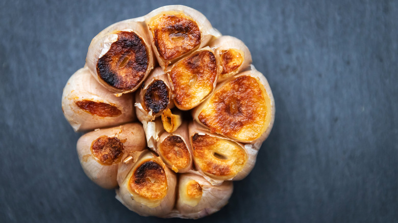A globe of roasted garlic is photographed from above.