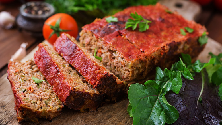 Sliced meatloaf on a cutting board.
