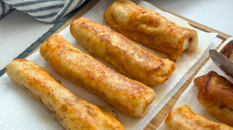 Pizza mozzarella sticks on paper towel-lined board