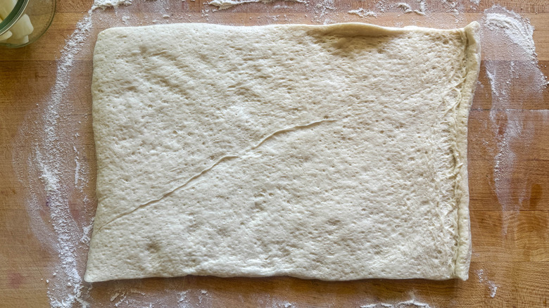 pizza dough on floured board