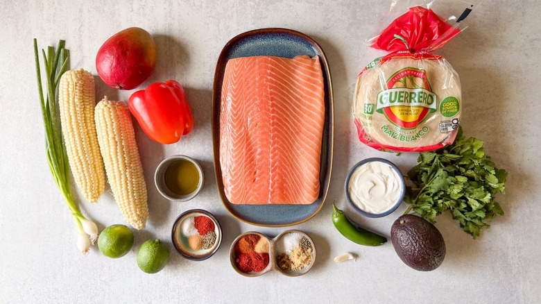 Slow-baked salmon tacos with mango-corn salsa ingredients on countertop