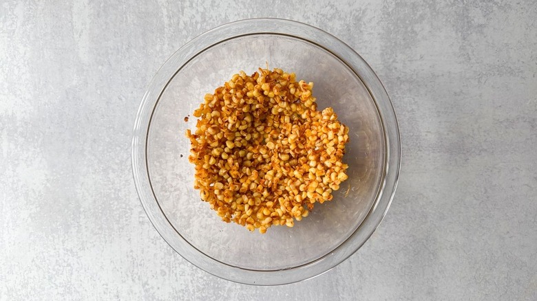 Roasted corn kernels cooling in glass bowl