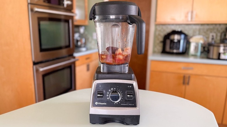 Cooked chilies, tomatoes, onion, and garlic in blender with beef stock, citrus juice, vinegar, and herbs