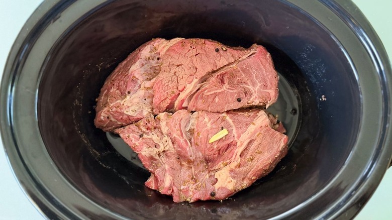 Marinated beef chuck in slow cooker insert
