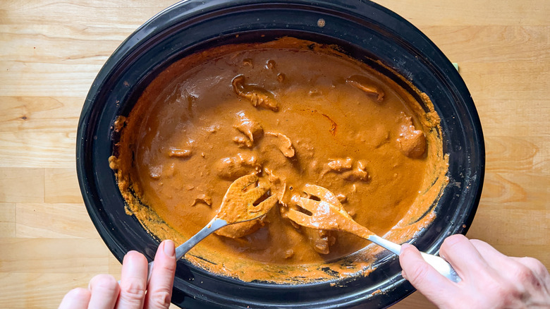 Shredding chicken mole in slow cooker