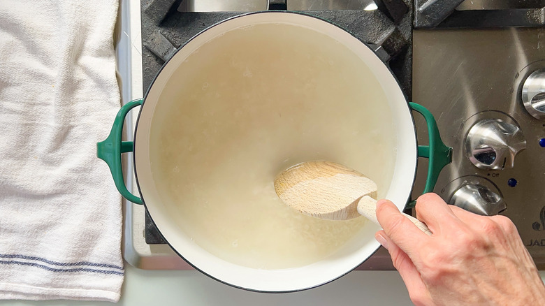 Rice cooking in pot on stove