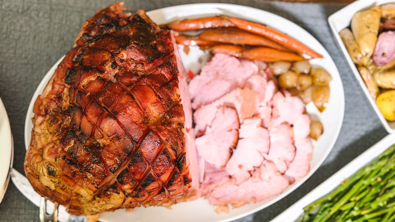Slow cooker Easter ham with apricot and Kahlua on platter with baby vegetables