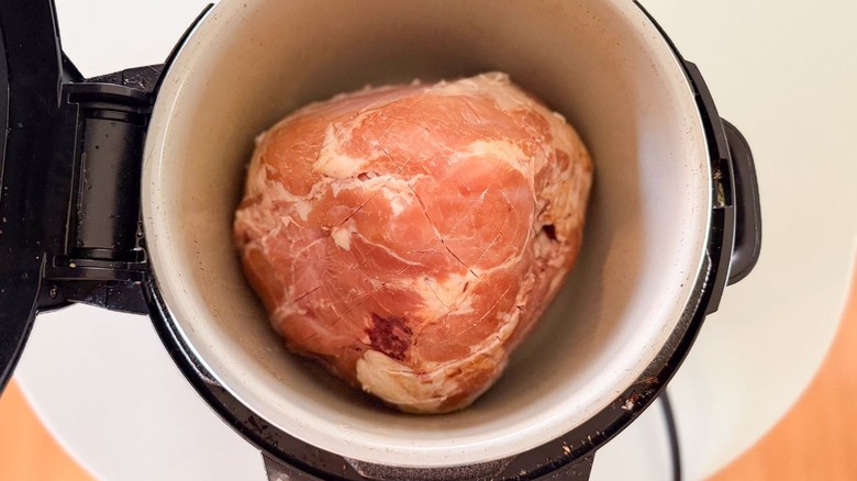 Scored half ham in slow cooker with open lid
