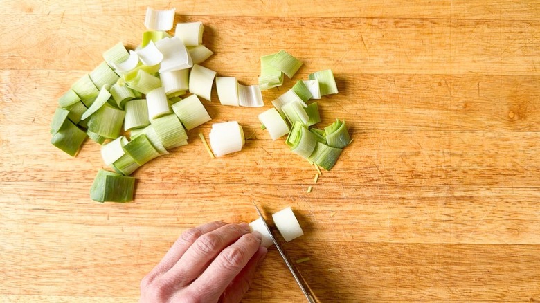 Slicing leeks on cutting board