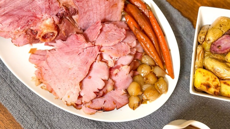 Slow cooker Easter ham with apricot and Kahua carved on platter with pan vegetables