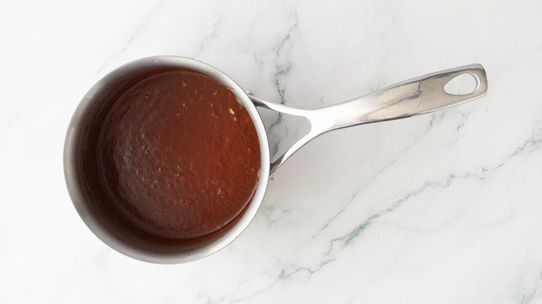 Cooked barbecue sauce in a small saucepan