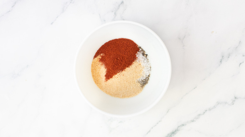 Assorted dry seasonings in a small white bowl