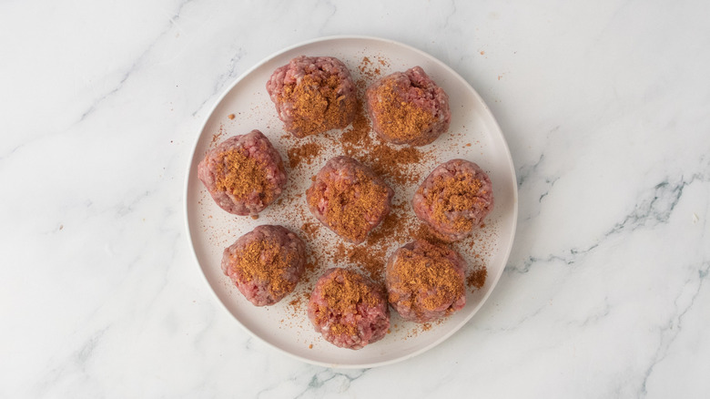 A plate filled with small portions of ground beef sprinkled with taco seasoning