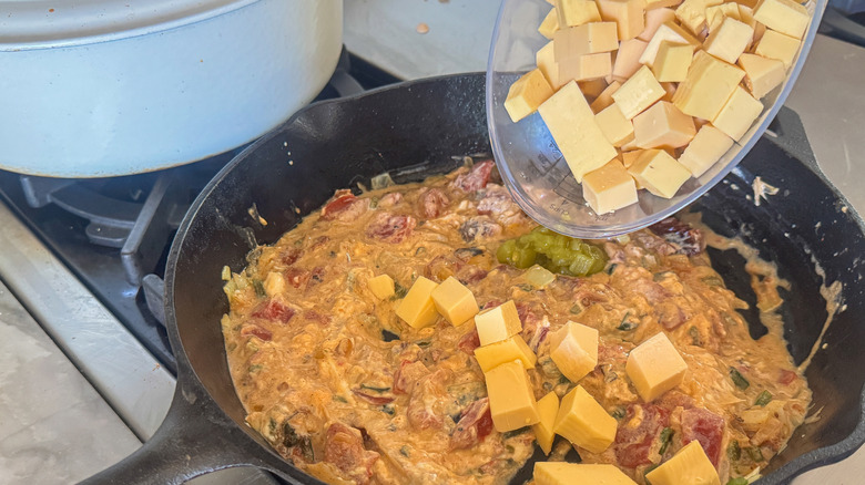 adding cheese to pan