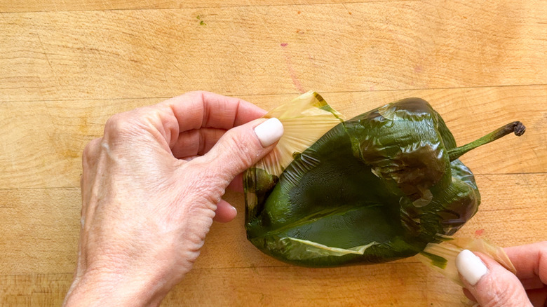 hand peeling poblano