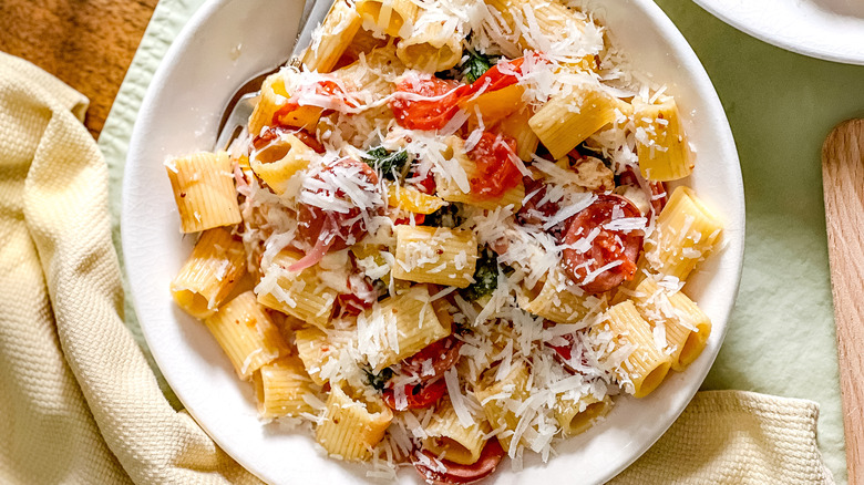 Smoky mustardy kielbasa pasta in bowl with napkin