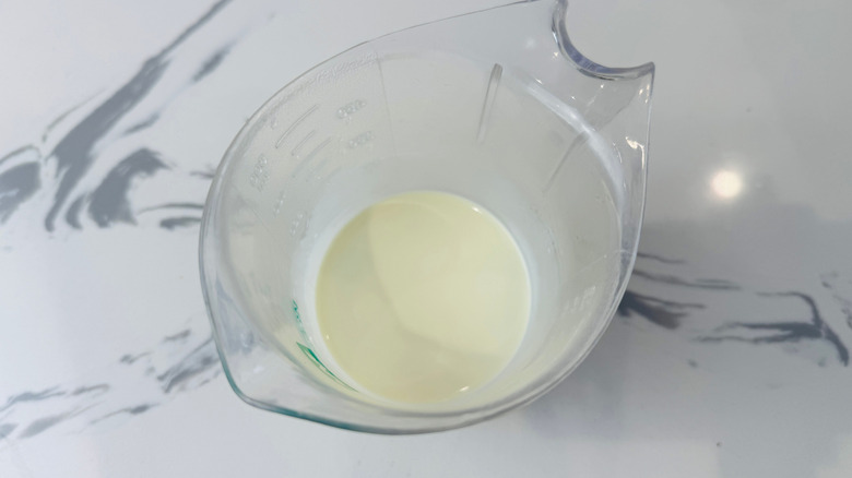 Cream in measuring cup