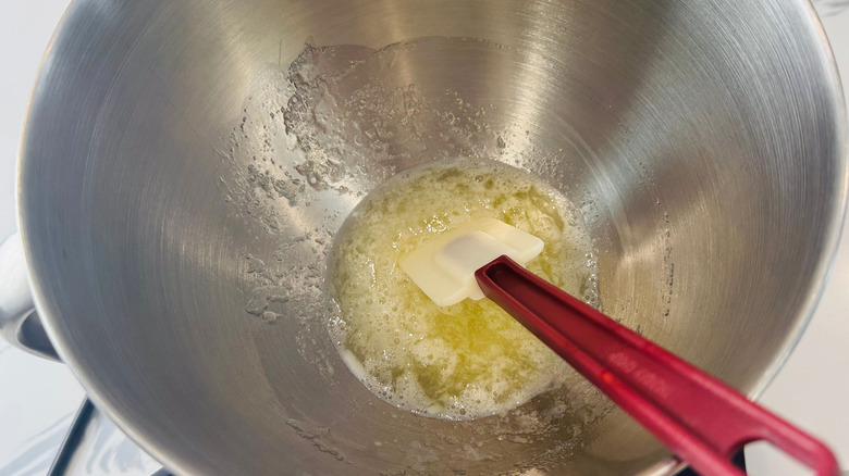 Egg whites and rubber spatula in large bowl