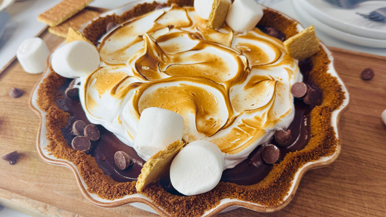 Decorated s'mores pie on wooden board