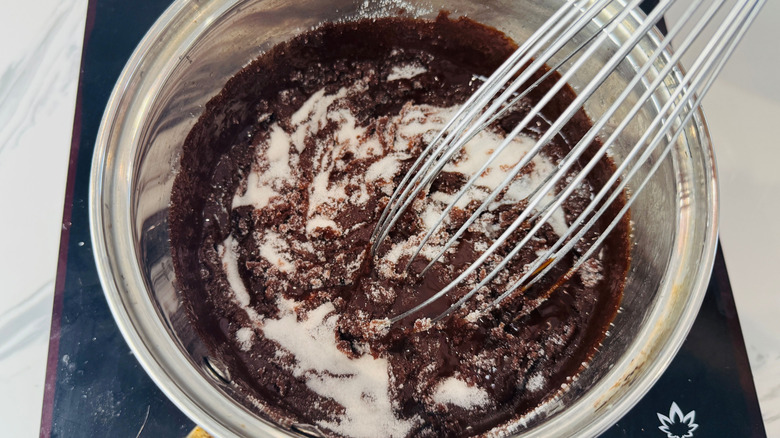 Sugary chocolate mixture and whisk in saucepan