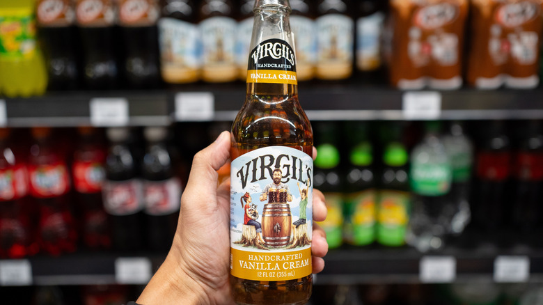 person holding Virgil's Vanilla Cream soda in a store