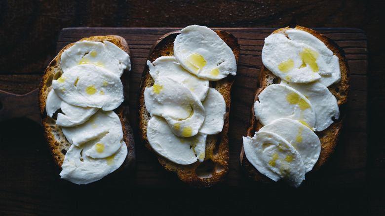 slices of toasted bread with buffalo mozzerella and olive oil