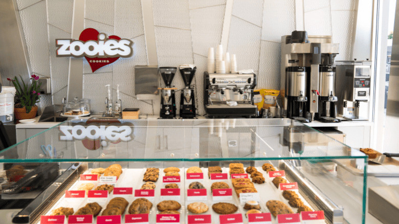 Interior of Zooies Cookies featuring coffee makers and display case of cookies