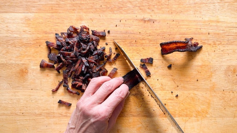 Chopping bacon on cutting board