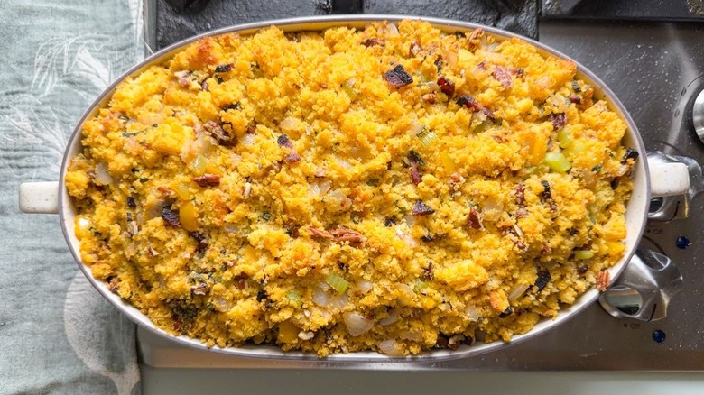 Southern-style homemade cornbread dressing in casserole dish on stovetop