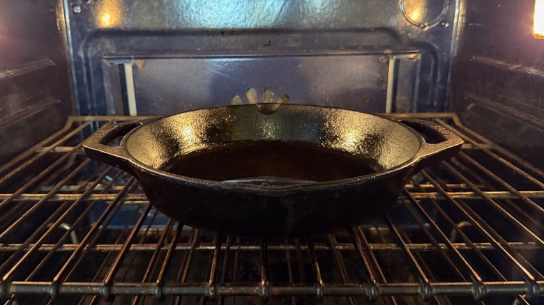 Cast iron skillet heating in oven