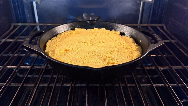 Cornbread batter in skillet baking in oven