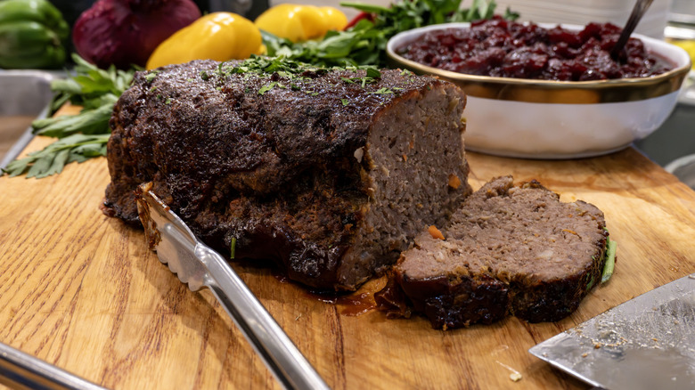 sliced meatloaf on a wooden cutting board