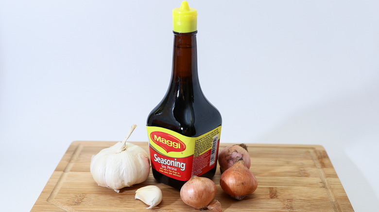 Maggi seasoning on a cutting board with onions
