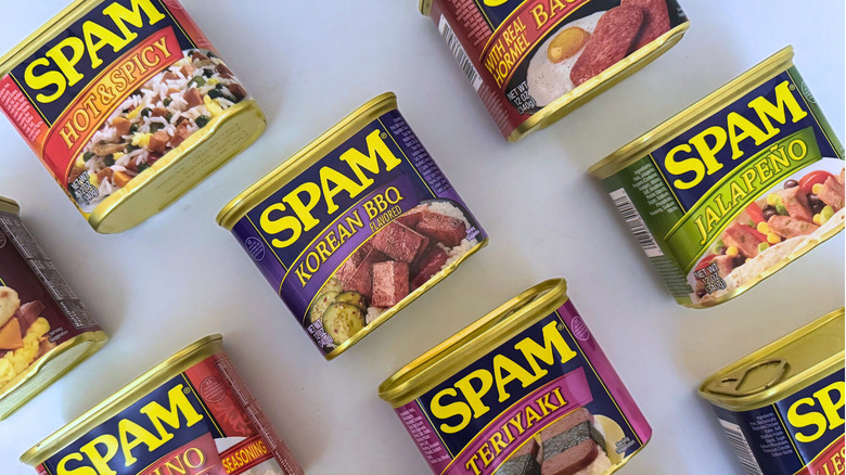 Variety of canned Spam on white surface