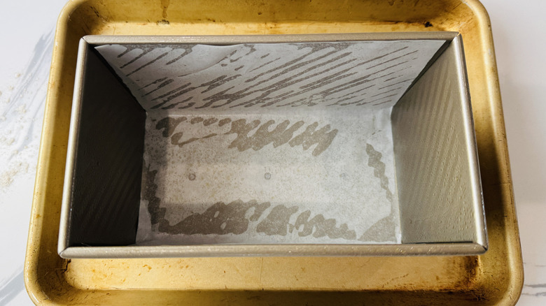 Lined loaf pan over baking sheet