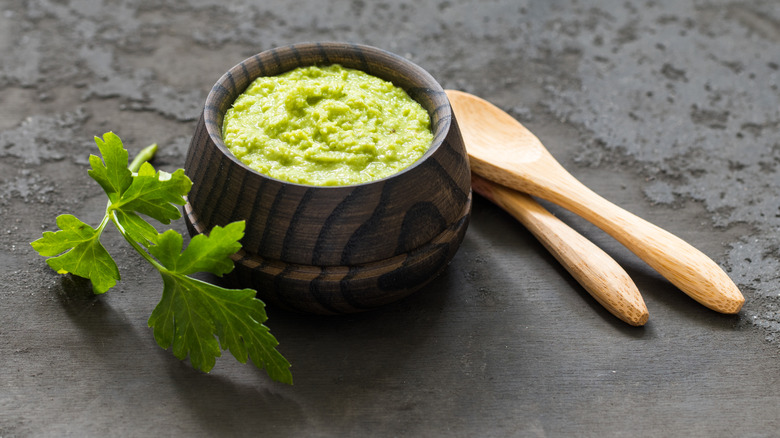 A serving of wasabi paste in a bowl with spoons