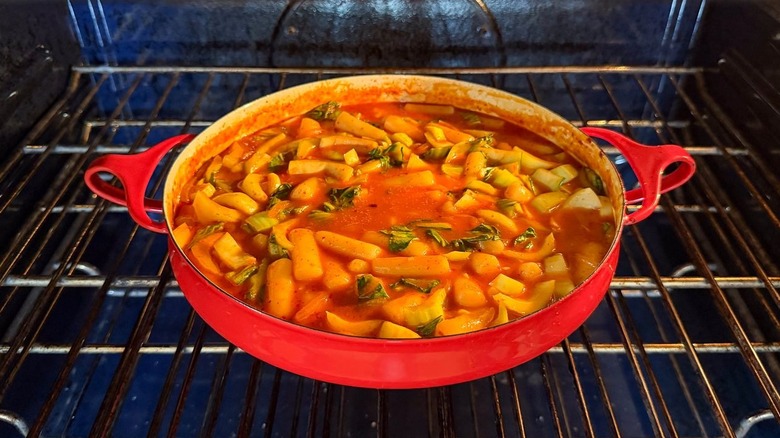 Tteokbokki baking in red pan in oven