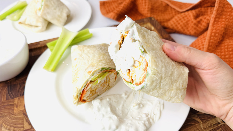 Buffalo chicken wrap dipped into blue cheese dressing