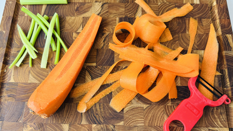 Preparing carrots and celery on cutting board