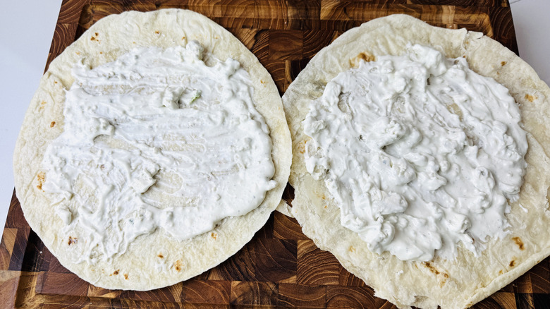 Blue cheese dressing spread over tortillas