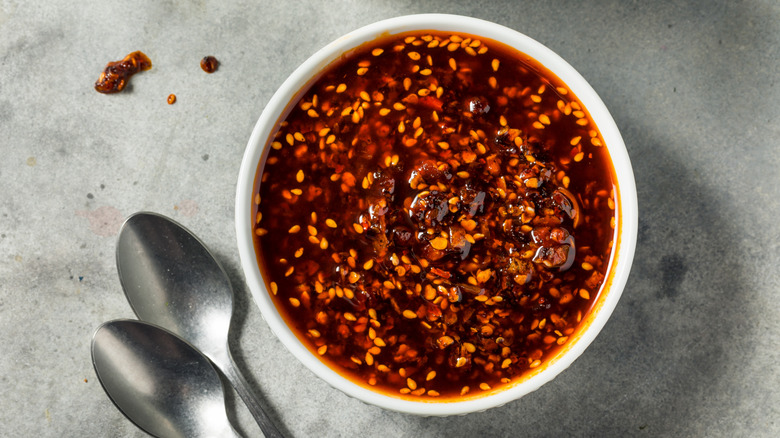 A bowl of chili crisp with two spoons