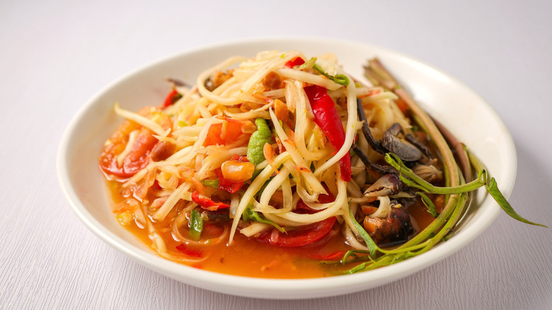 A bowl of spicy som tum papaya salad