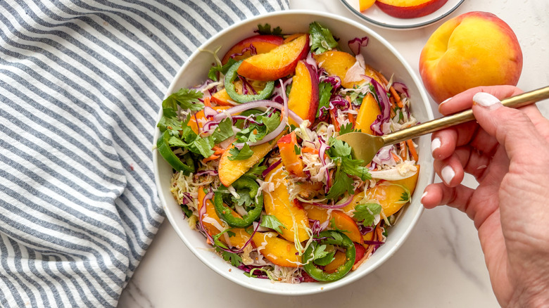 hand with fork in salad