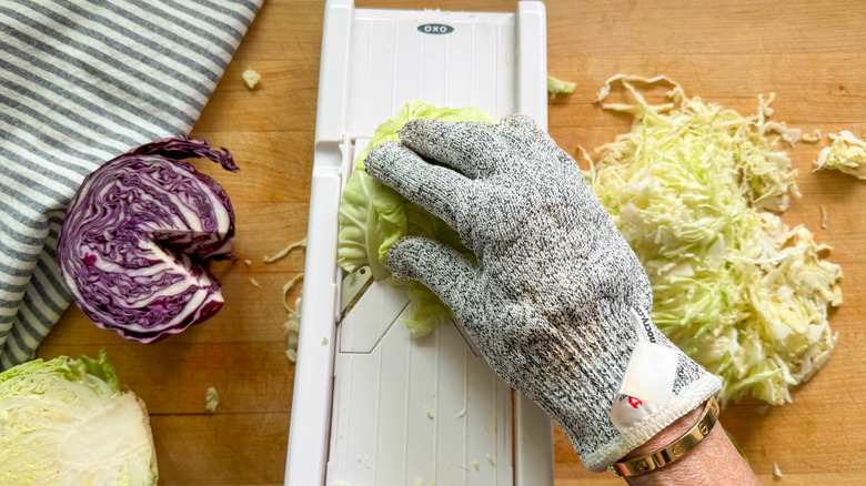 hand slicing cabbage on mandoline