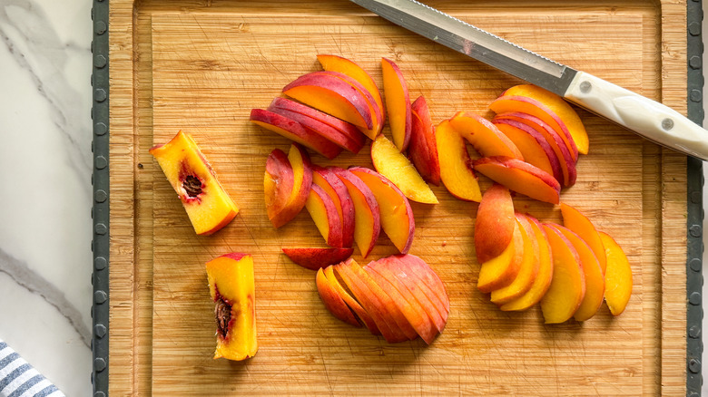 sliced peaches on board