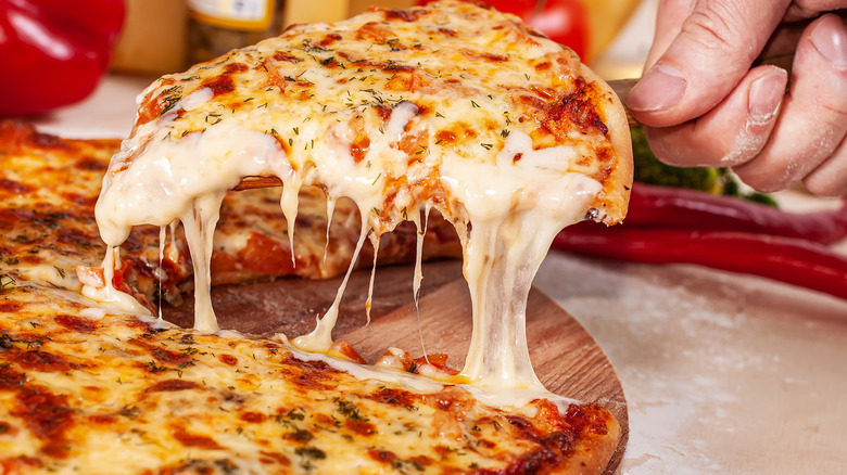A cheesy slice of pizza, complete with a satisfying cheese pull.