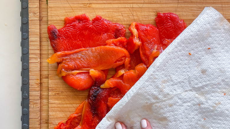 hands blotting peppers